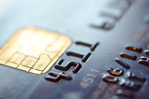 A close up shot of a smart chip on a credit card.